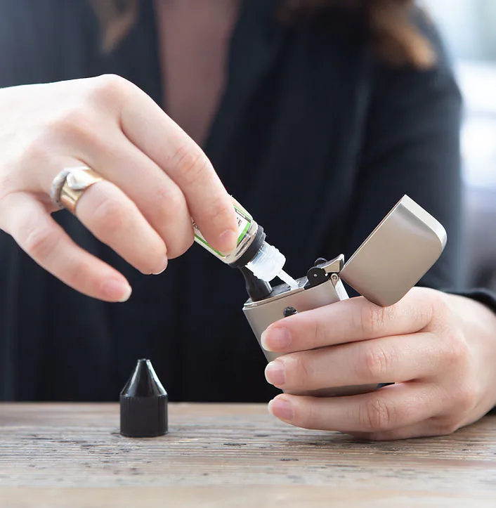Person filling a lighter